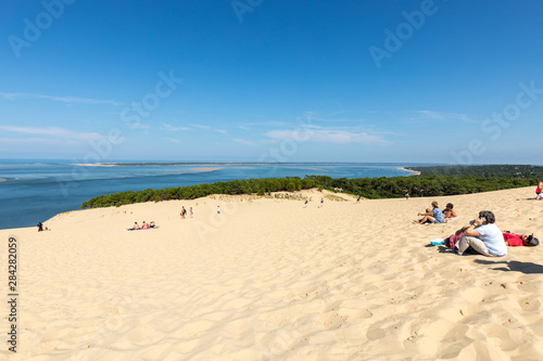Fototapeta Naklejka Na Ścianę i Meble -  People on the Dune of Pilat, the tallest sand dune in Europe. La Teste-de-Buch, Arcachon Bay, Aquitaine, France