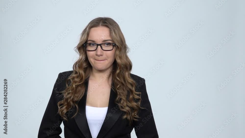Business woman with smile and excitement looking at camera on gray background, slow motion Business woman with smile and excitement looking at camera on gray background, slow motion