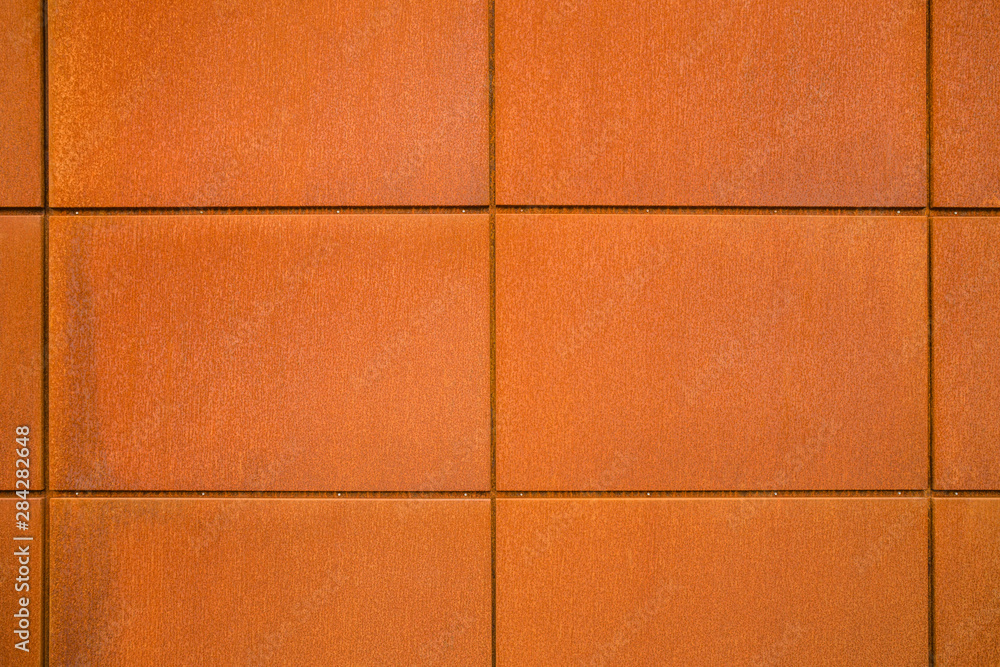 Naklejka premium Cortenstahl Hintergrund Fassadenplatten aus Eisenblech mit Rost im Industrie Stil - Background facade panels of sheet iron with rust in industrial style