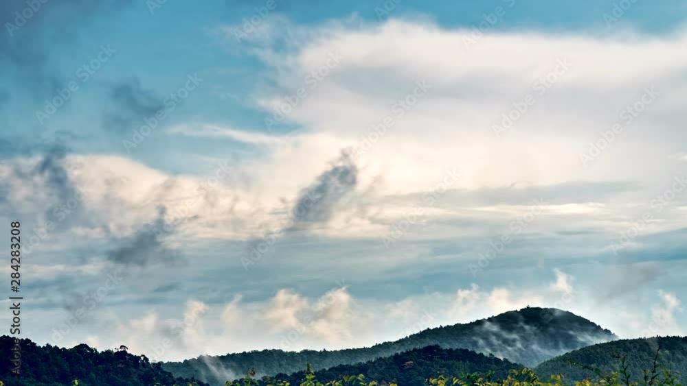 Timelapse of different layers of clouds moving fast and slowly above european wooded hills 4K Timelapse of different layers of clouds moving fast and slowly above european wooded hills 4K