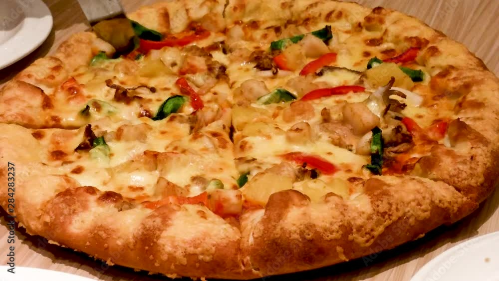 Happy to share, cutting seafood pizza in the Italian restaurant Happy to share, cutting seafood pizza in the Italian restaurant