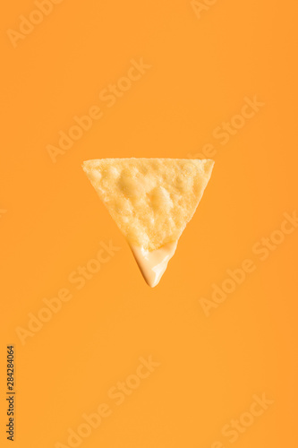 top view of crispy nacho isolated on orange, Mexican cuisine