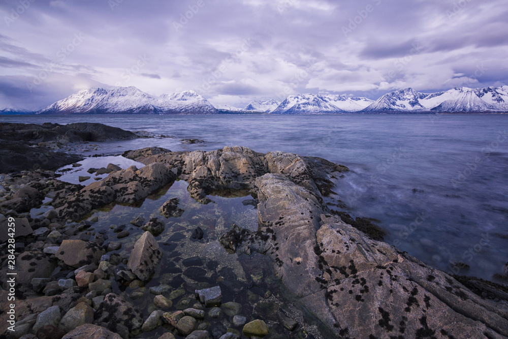 Cold and freezing temperatures on the coast of Lofotten, Norway. Pure natural beauty yet harsh conditions. Rocky seaside, moody skies. Cold and freezing temperatures on the coast of Lofotten, Norway. Pure natural beauty yet harsh conditions. Rocky seaside, moody skies.