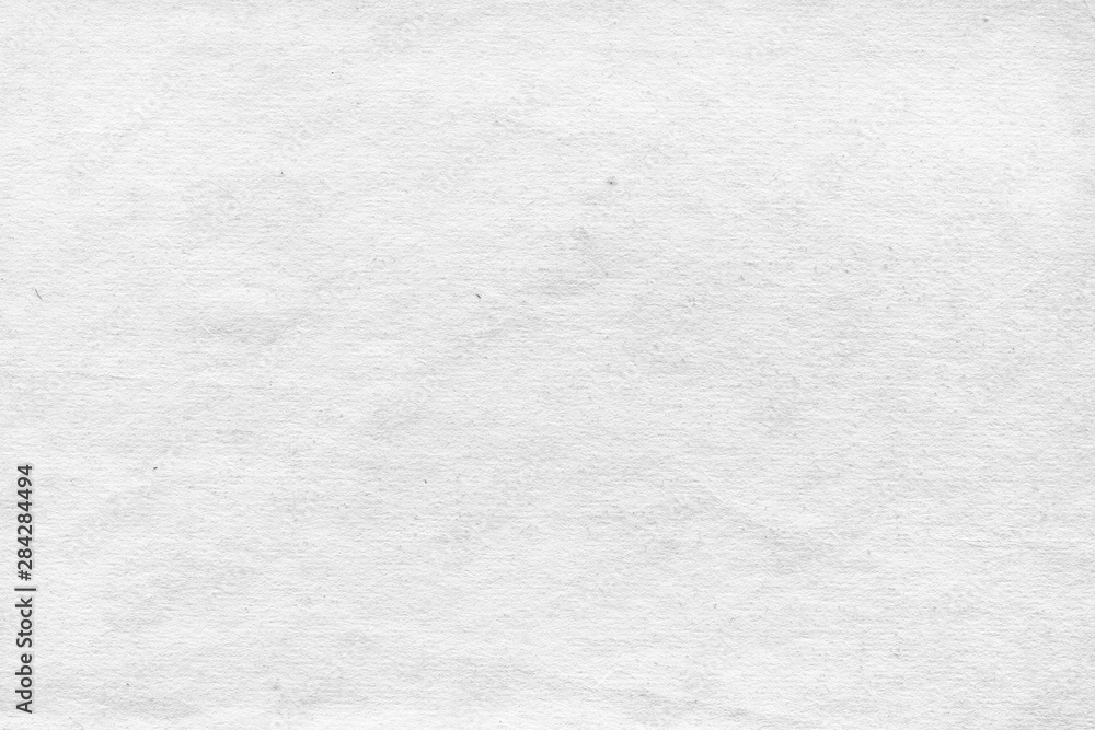 Fototapeta premium Cardboard white texture close-up. Light old paper background. Grunge concrete wall. Vintage blank wallpaper.