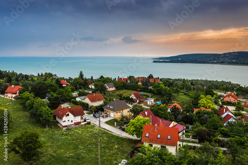 Balatonfuzfo, Hungary - Weekend cabins at the hilltop of Balatonfuzfo at sunset with Balatonalmadi at background by Lake Balaton photo