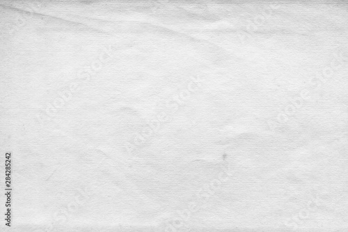 Cardboard white texture close-up. Light old paper background. Grunge concrete wall. Vintage blank wallpaper.