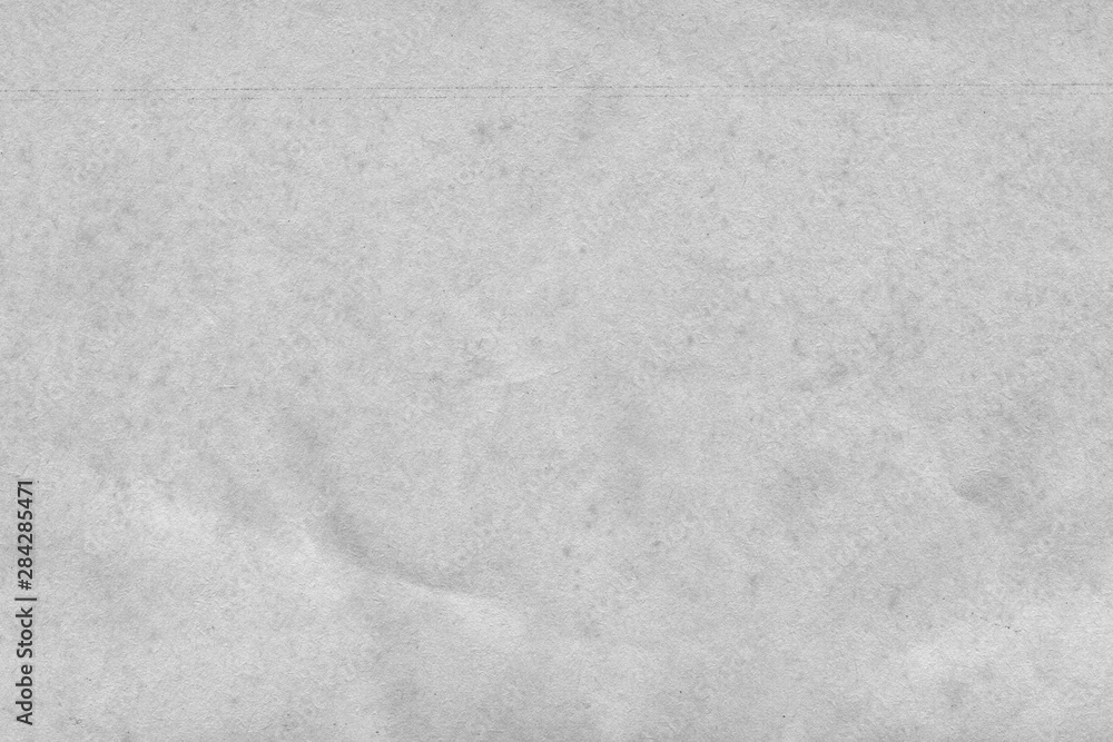 Fototapeta premium Cardboard white texture close-up. Light old paper background. Grunge concrete wall. Vintage blank wallpaper.