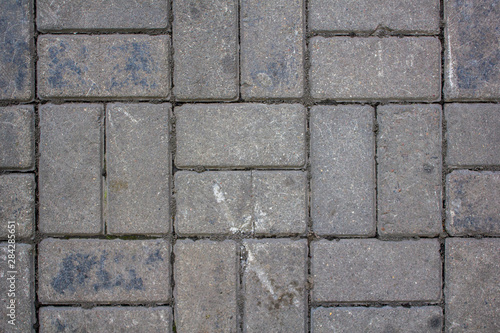 gray shabby paving slabs of rectangular bricks. rough surface texture