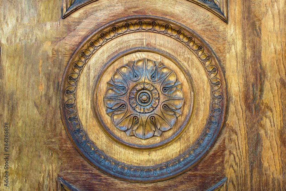 round ornament in a wooden wall. rough surface texture