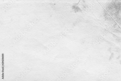 Cardboard white texture close-up. Light old paper background. Grunge concrete wall. Vintage blank wallpaper.