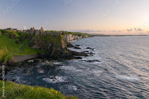 Dunluce Castle is a now-ruined medieval castle in Northern Ireland, the seat of Clan McDonnell. It is located on the edge of a basalt outcropping in County Antrim