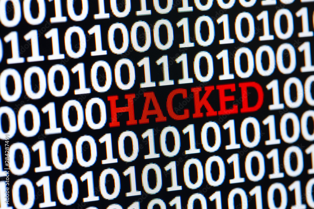 Red inscription HACKED in binary code of ones and zeros. Cyber attack electronic devices. Red inscription HACKED in binary code of ones and zeros. Cyber attack electronic devices.