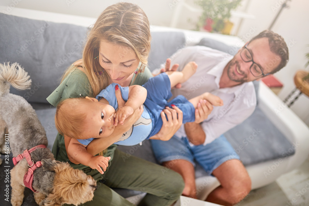 Parents playing with a baby at home. Parents playing with a baby at home.
