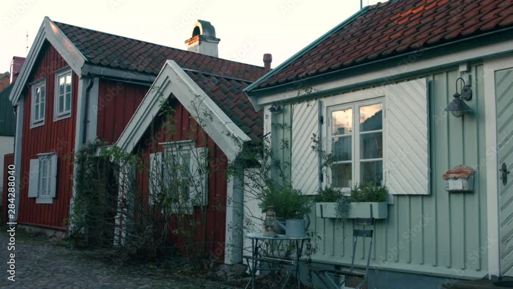 Old town in Kalmar. Small houses next to a cobblestone street during the evening. Old town in Kalmar. Small houses next to a cobblestone street during the evening.