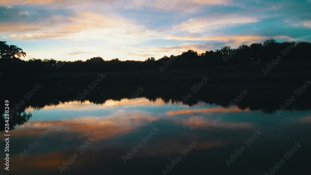 Aerial drone video of a glassy lake with cotton candy sky. Aerial drone video of a glassy lake with cotton candy sky.