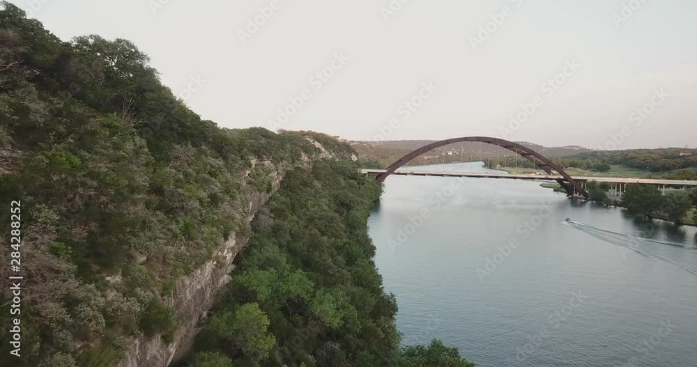 Aerial Drone Shot of the hills in Austin, TX, with the 360 bridge in the background. Aerial Drone Shot of the hills in Austin, TX, with the 360 bridge in the background.