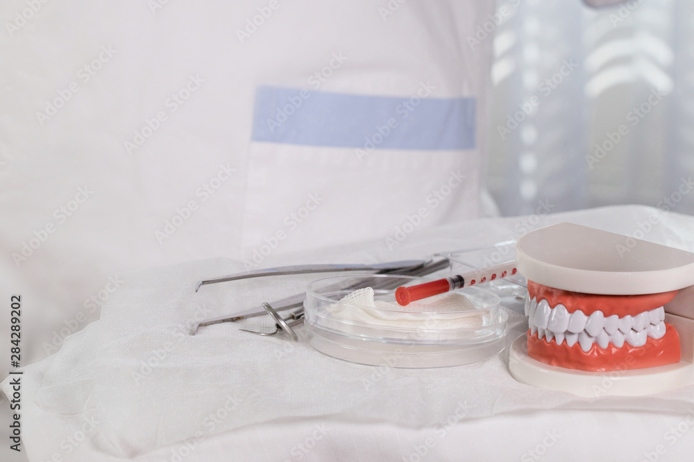Sterile cotton napkins and stomatological tools on a table. Closeup Sterile cotton napkins and stomatological tools on a table. Closeup