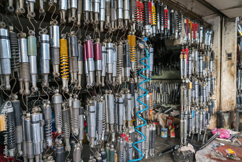Many old shock absorbers hanging at a repair shop on Hanoi street, Vietnam