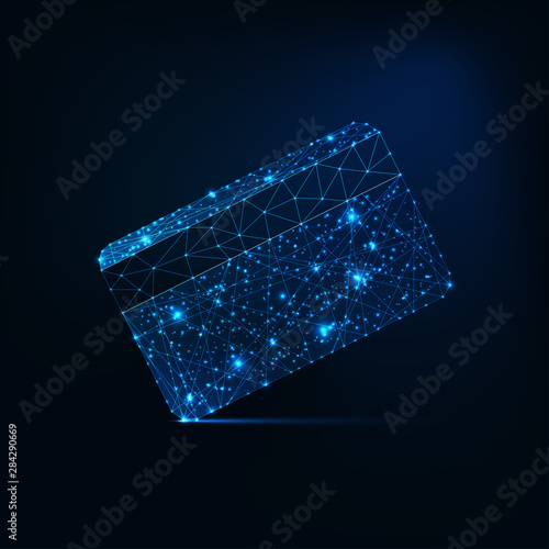 Futuristic glowing low polygonal credit card isolated on dark blue background.