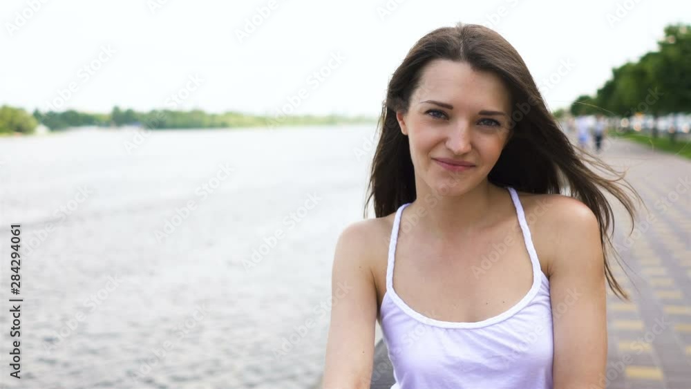 4k. Pretty smiling woman stand in summer city area. Face portrait 4k. Pretty smiling woman stand in summer city area. Face portrait