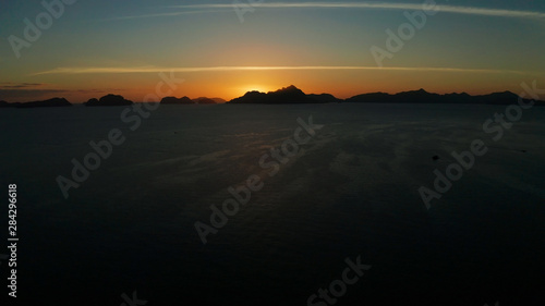 aerial view tropical sunset over the sea background of mountains. El nido, Philippines, Palawan. seascape with tropical islands at sunset time. Summer and travel vacation concept