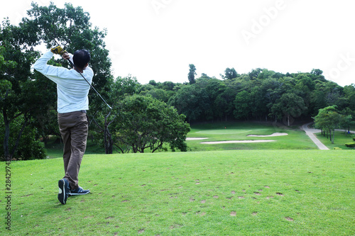 Asian golfer hit a golf ball by golf-club driver at golf course