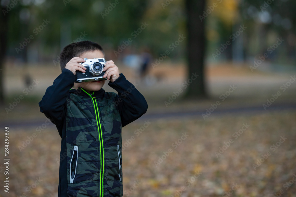 Boy With Retro Camera in Park Boy With Retro Camera in Park