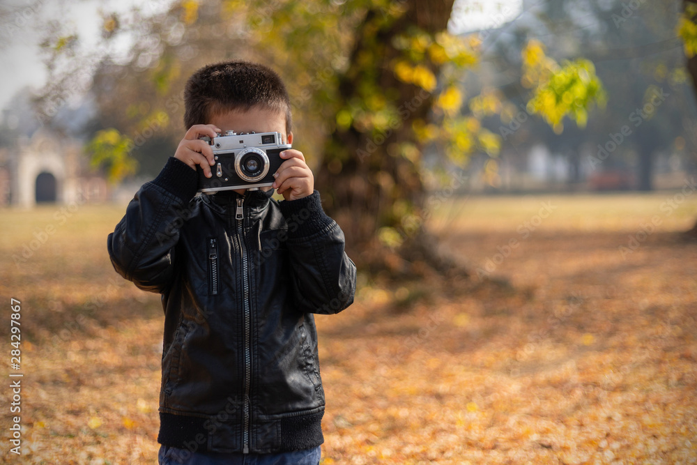 Boy With Retro Camera in Park Boy With Retro Camera in Park