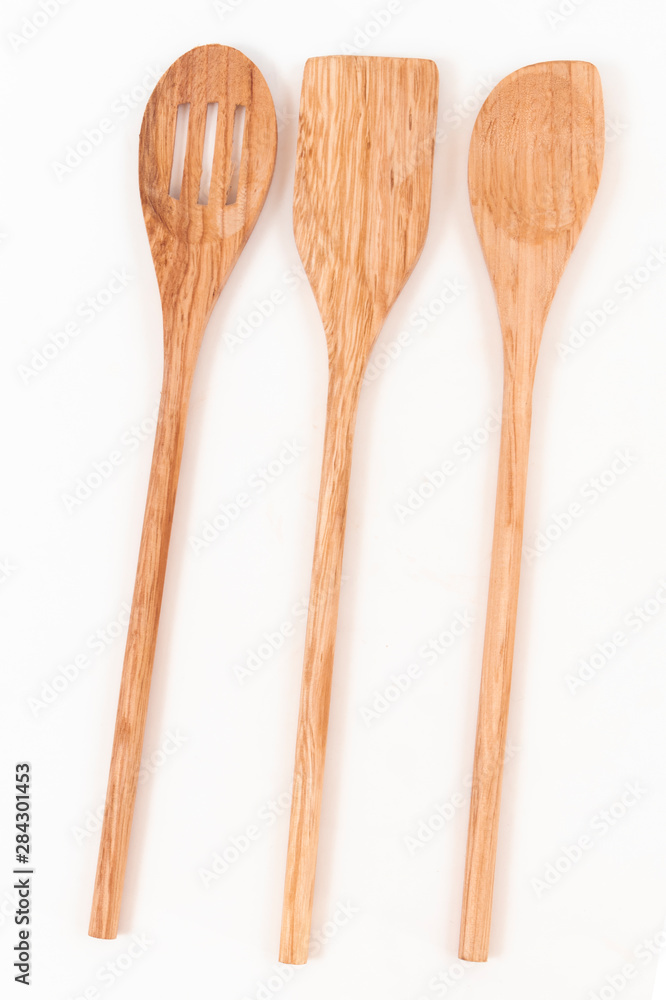 Top view of three wooden ladles on a white background Top view of three wooden ladles on a white background