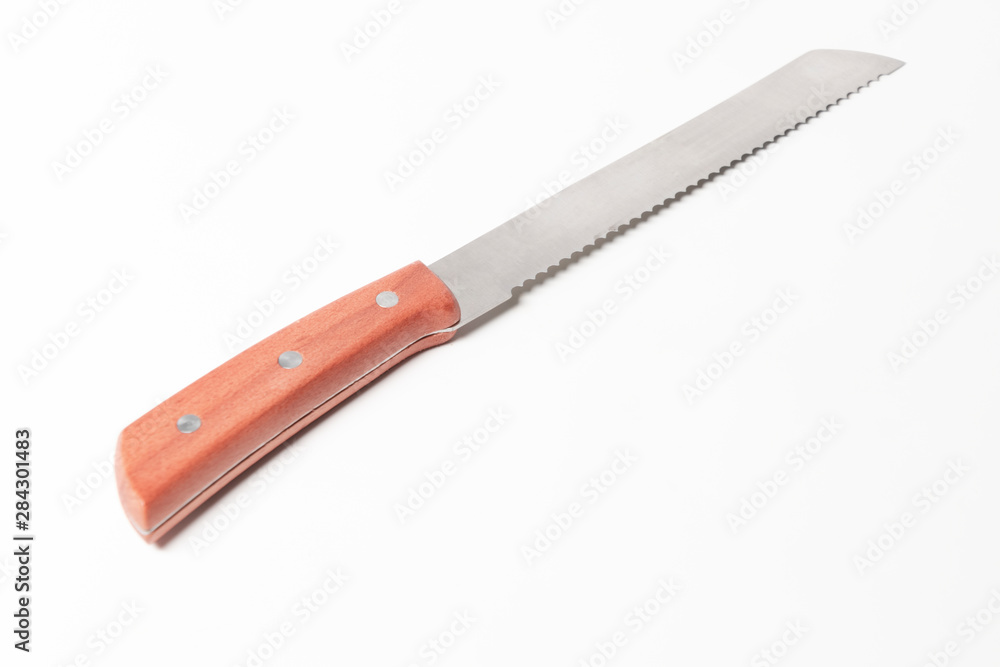 A beautiful knife to cut bread on a white background, saw knife A beautiful knife to cut bread on a white background, saw knife