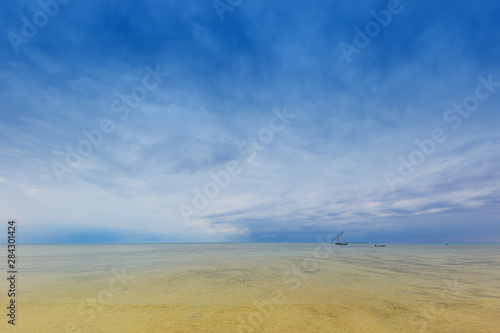 idylic outdoor scene with distant horizon calm ocean water and a dramatic clouded sky