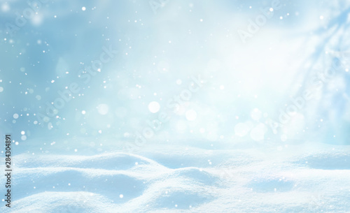 Winter snow background with snowdrifts  beautiful light and snow flakes on blue sky  beautiful bokeh circles  copy space.