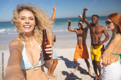 Group of friends having fun together on the beach