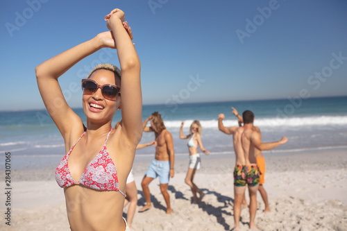 Group of friends having fun together on the beach