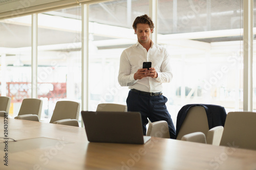 Businessman using mobile phone in the conference room