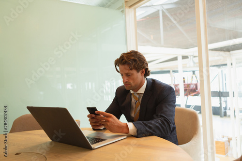 Businessman using mobile phone in the conference room