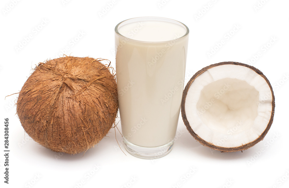 Coconut milk with fresh whole nut and half isolated on a white background. Creative cosmetic concept. Top view, flat lay Coconut milk with fresh whole nut and half isolated on a white background. Creative cosmetic concept. Top view, flat lay