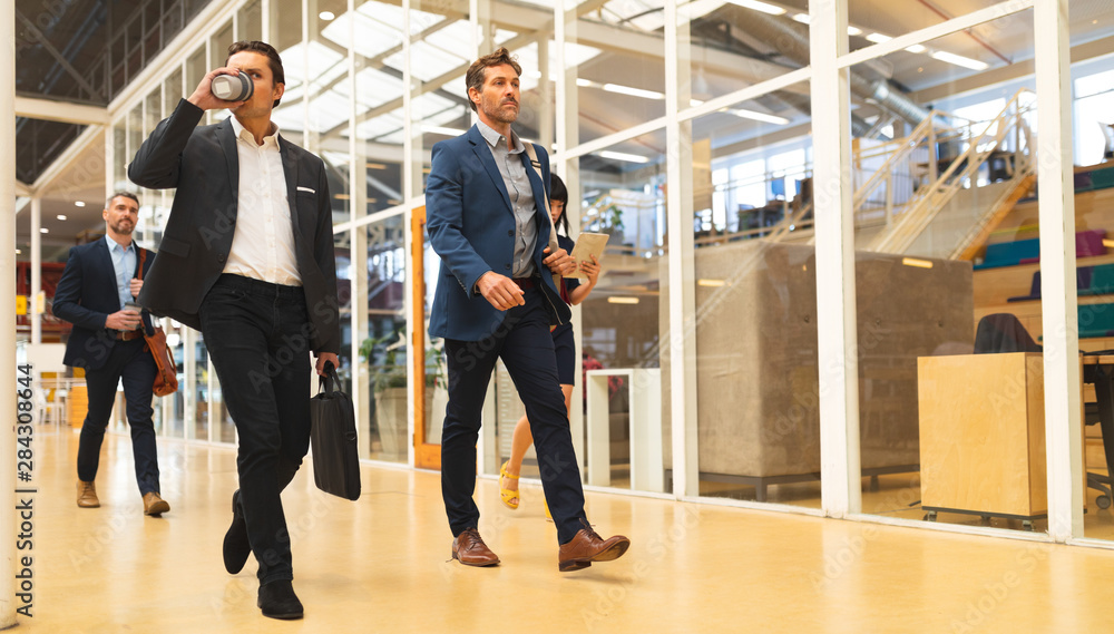 Obraz premium Business people walking together in the corridor at office