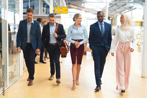 Business people walking together in the corridor at office