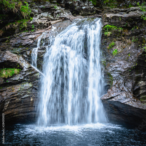 Waterfall in Scottish woodland.