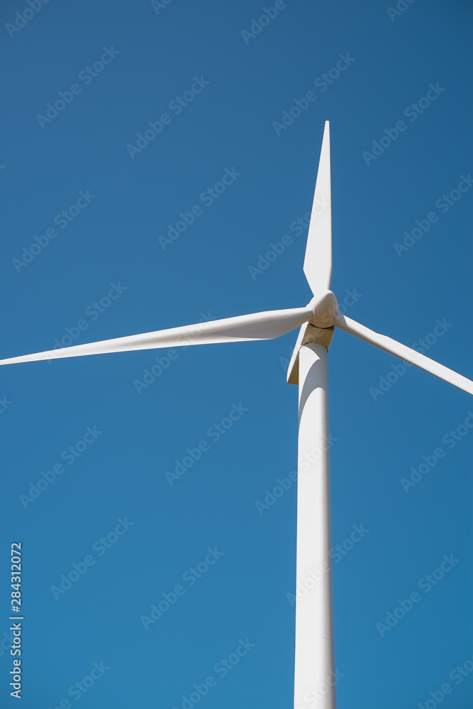 Wind turbine detail on blue background - energy save concept. Wind turbine detail on blue background - energy save concept.
