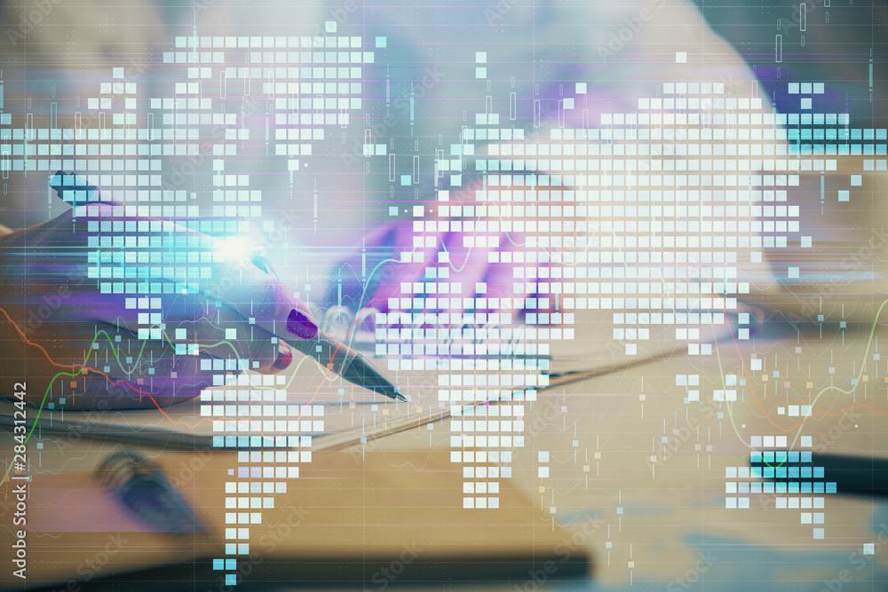 Obraz premium International business hologram over hands taking notes background. Concept of success. Multi exposure