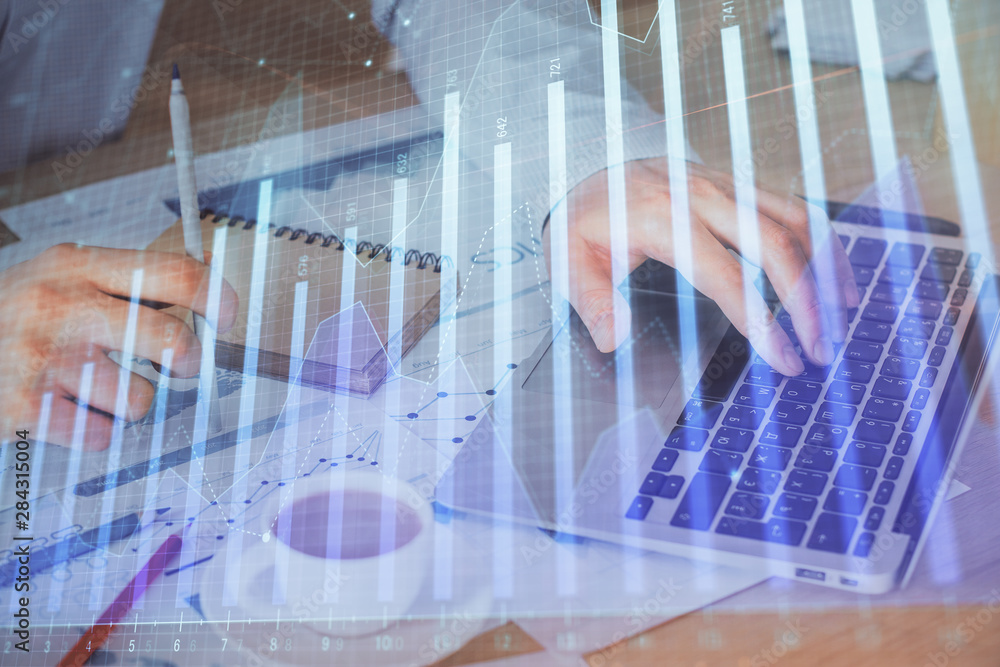 Forex graph with businessman working on computer in office on background. Concept of hardworking. Double exposure. Forex graph with businessman working on computer in office on background. Concept of hardworking. Double exposure.