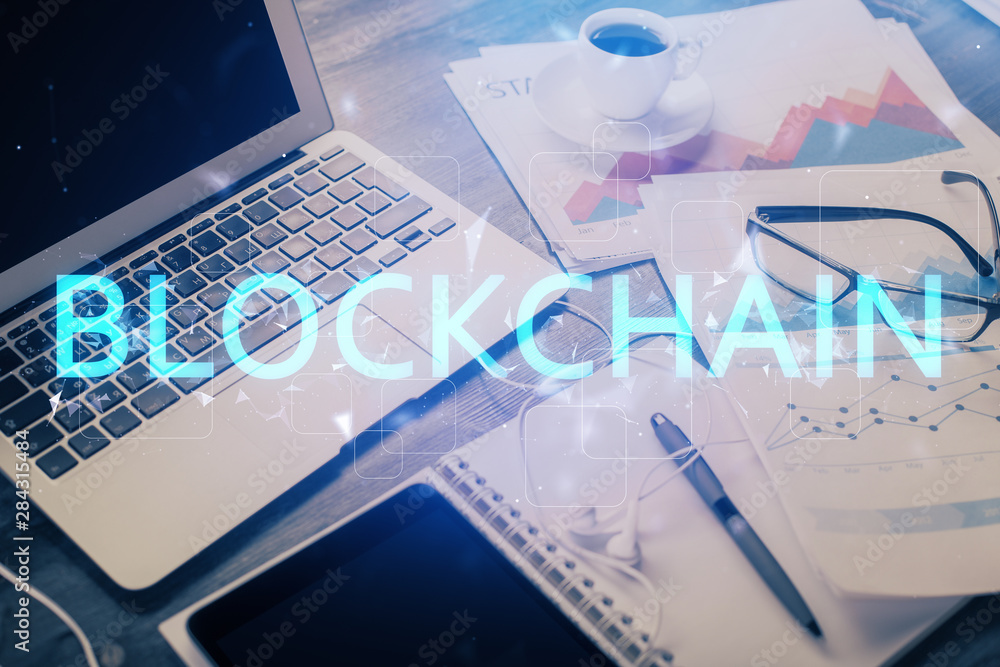 Double exposure of blockchain and crypto economy theme hologram and table with computer background. Concept of bitcoin cryptocurrency. Double exposure of blockchain and crypto economy theme hologram and table with computer background. Concept of bitcoin cryptocurrency.