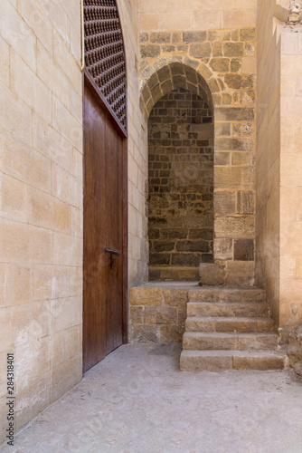 Stone staircase leading to vaulted entrance at stone bricks wall
