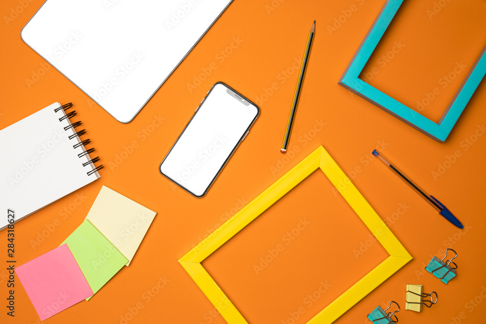 Flat lay desk concept with orange background Flat lay desk concept with orange background