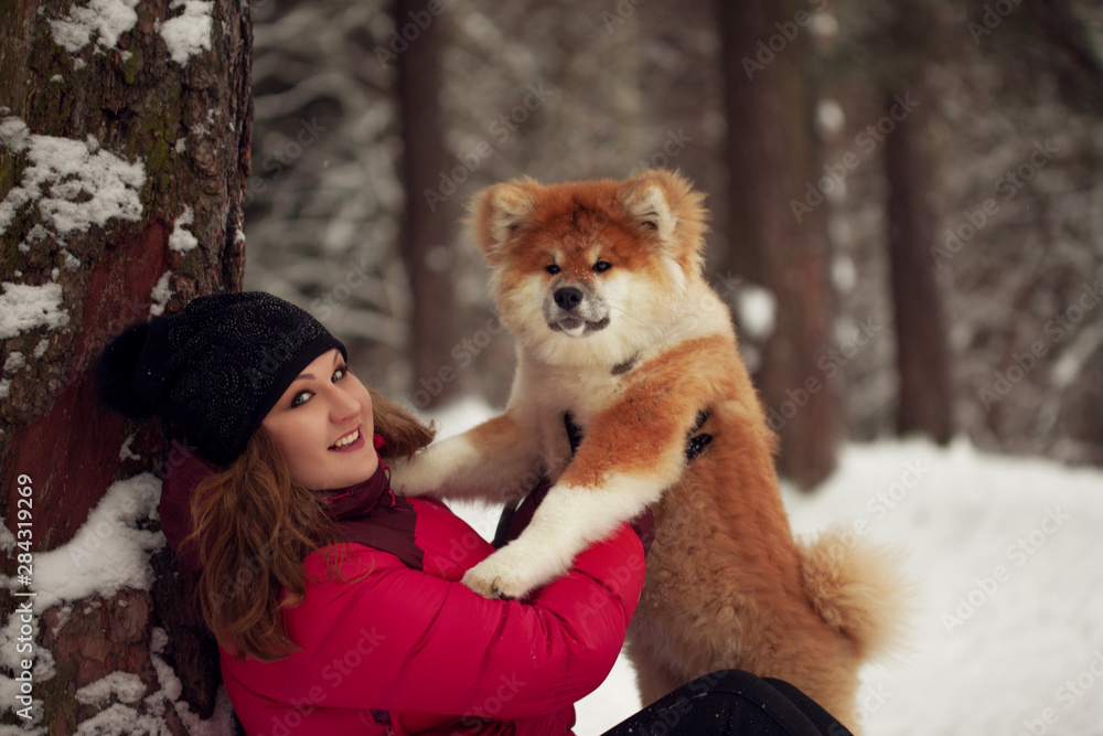Portrait with a cute fluffy puppy. Winter walk with a dog.