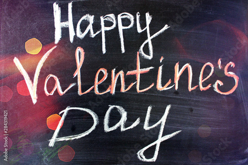 Love. I love you. Message of love. The inscription on the blackboard with chalk. Valentine's day theme. Dark grunge texture background. Copy space.