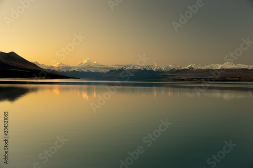 Spectacular panorama scenary of white Mount Cook and clear sky during sunset reflect in Pukaki Lake, South New Zealand.