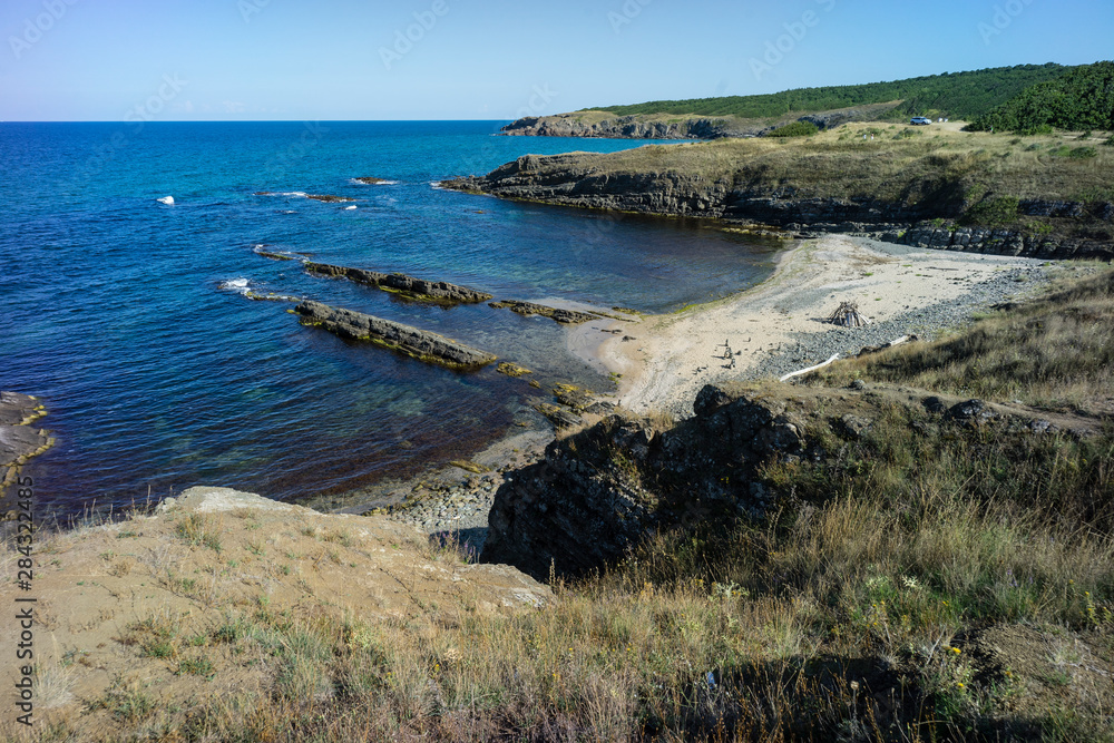 Fototapeta premium Coastline of Black Sea view from a high point showing bays of water with white sand amongst the rocky terrain edges.
